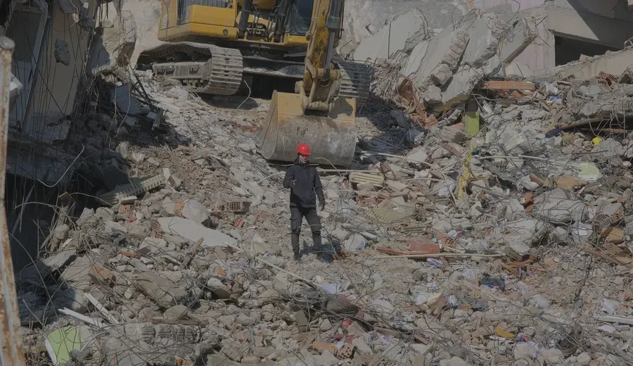 Excavator clearing a demolition site, near Poteet, Texas