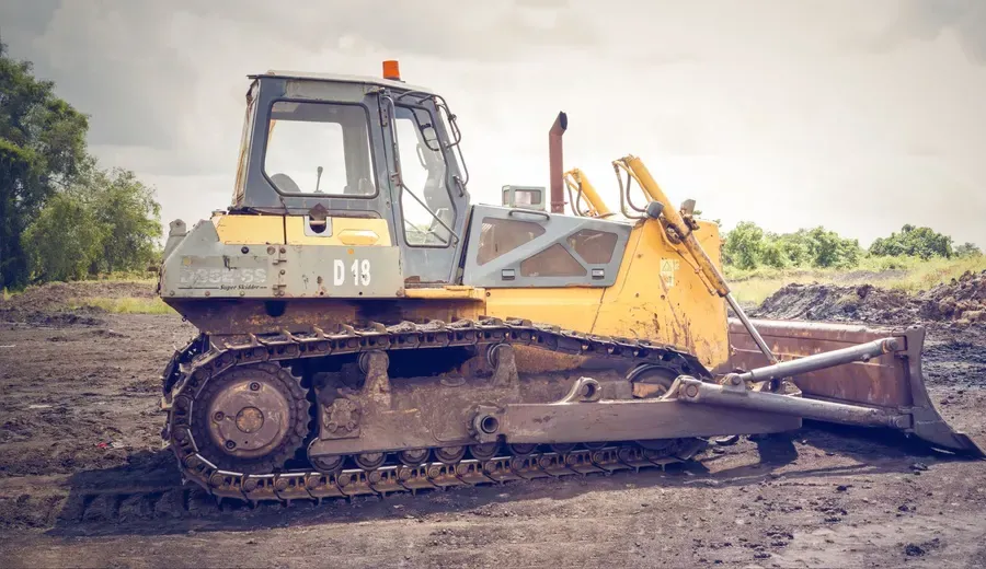 Loader clearing a lot where a mobile home was removed
